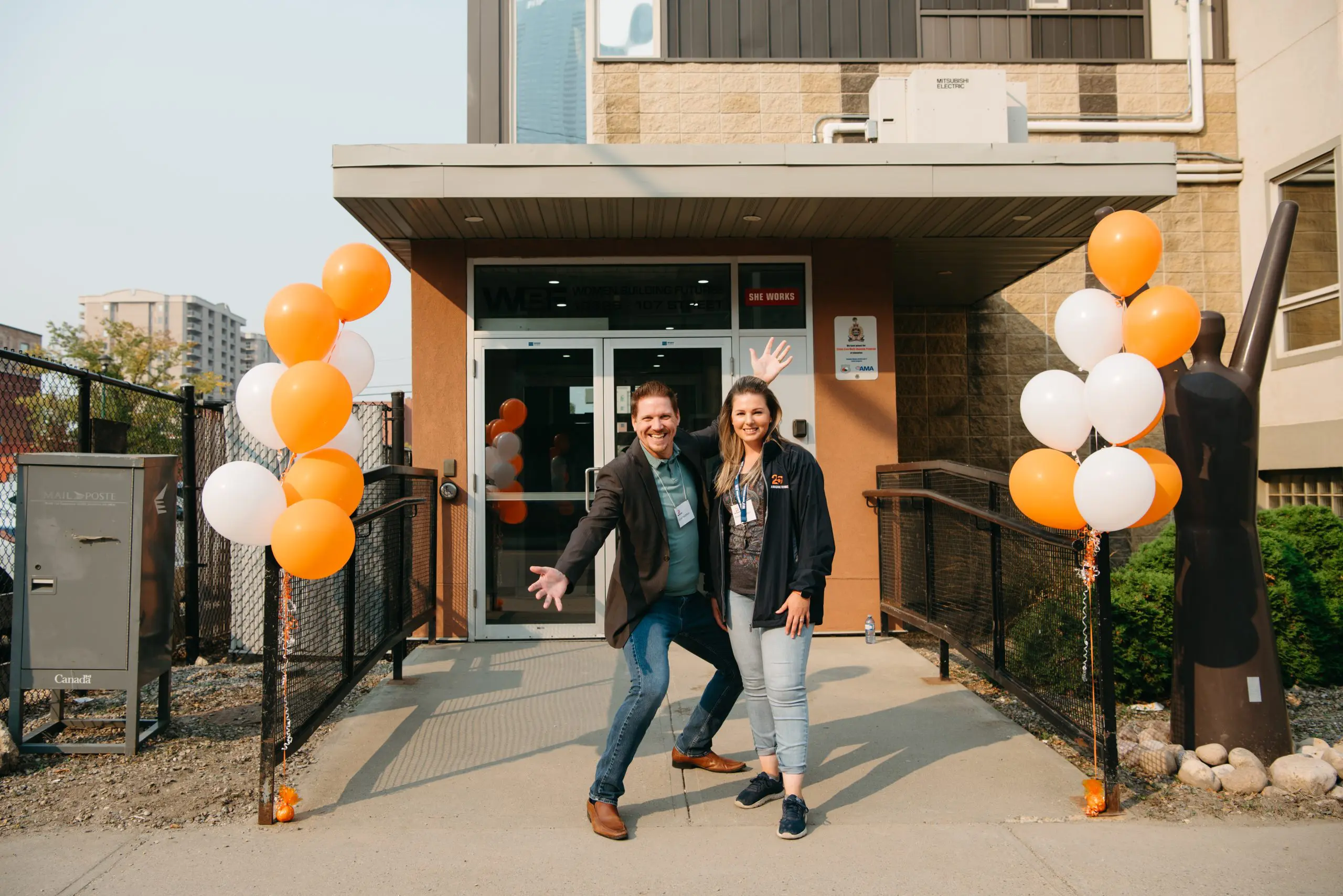 Two WBF employees pose outside of the training centre in Edmonton